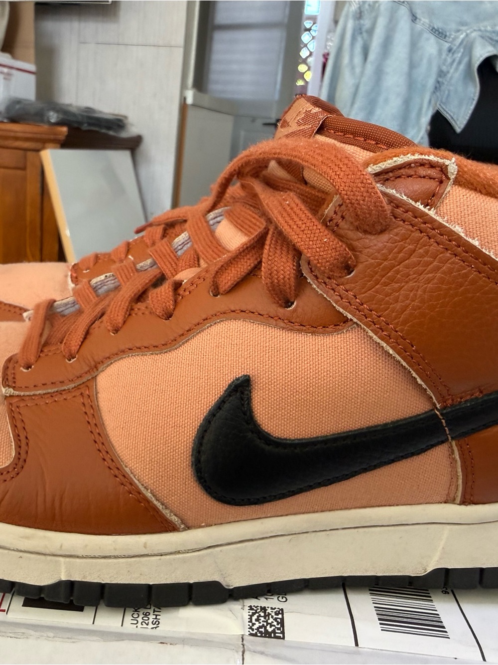 Nike Low-Top Sneakers in Rust Orange with Black Swoosh.